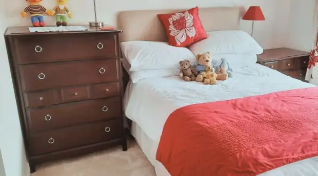 Bedroom with a red bed cover