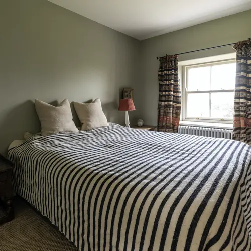 Bedroom with a made bed and bedside tables