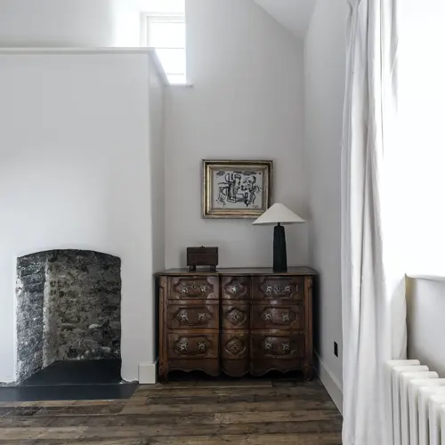 Bedroom with a fireplace and window