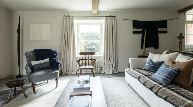Living room with sofas and a bright window