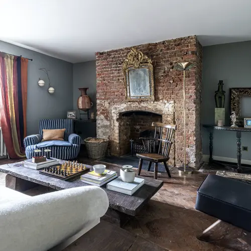 Sitting room with a fireplace and armchairs